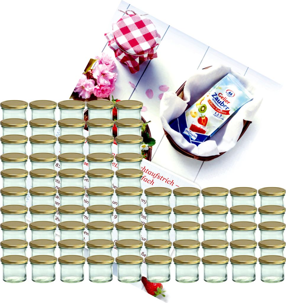 A collection of small glass jars with gold lids, arranged in rows, with some decorative elements like flowers and a packet of jelly powder in a basket.
