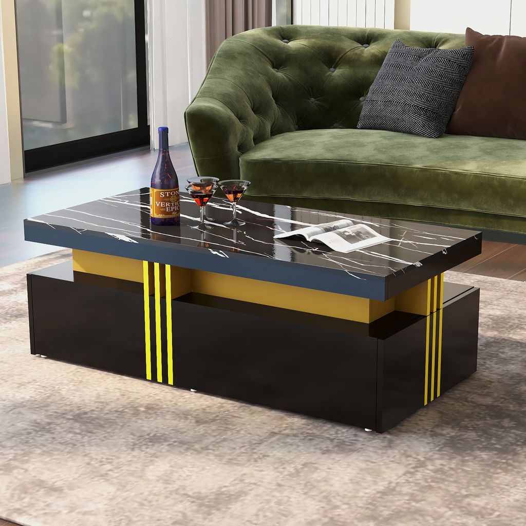 A modern coffee table with a marble-look top and gold accents is placed in a living room setting, next to a green sofa.