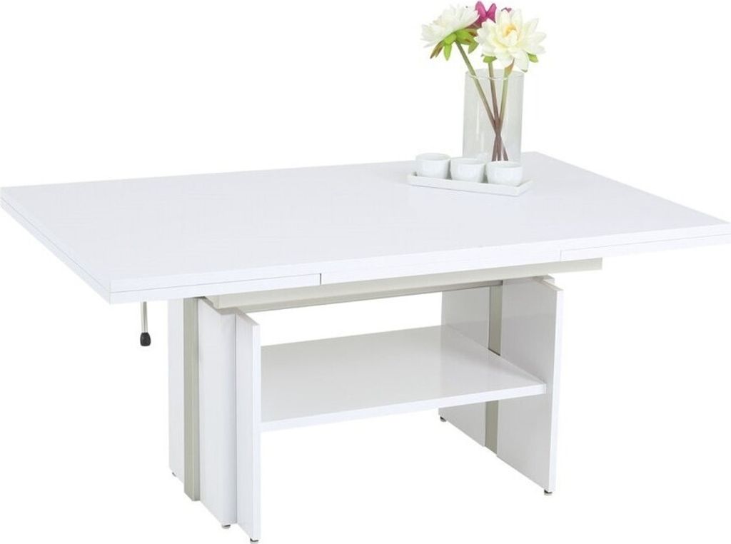 A white lift-top coffee table with a shelf underneath, shown against a white background. A vase with flowers and small white cups are on top of the table.