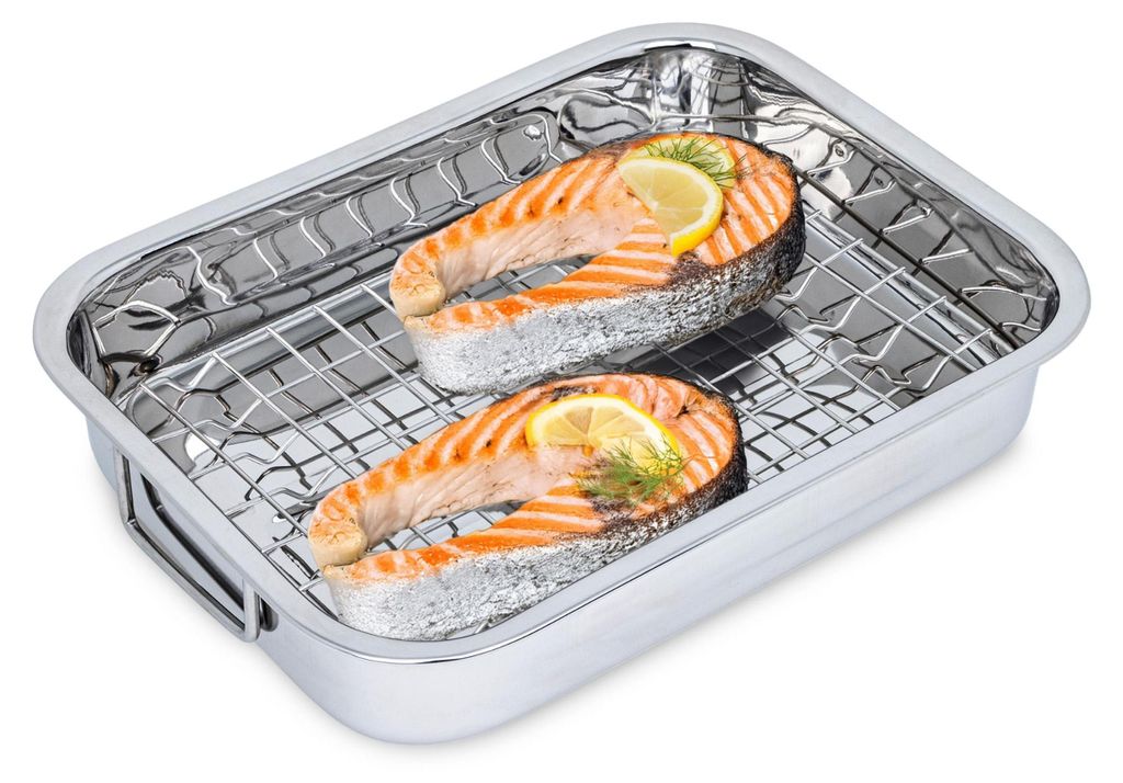 Two salmon steaks with lemon and dill in a roasting pan with a rack.