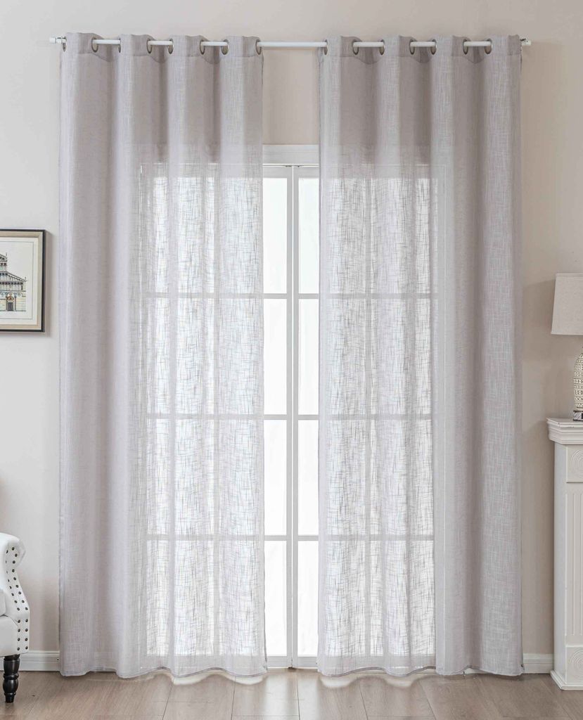 A pair of light gray sheer curtains hanging over a window.
