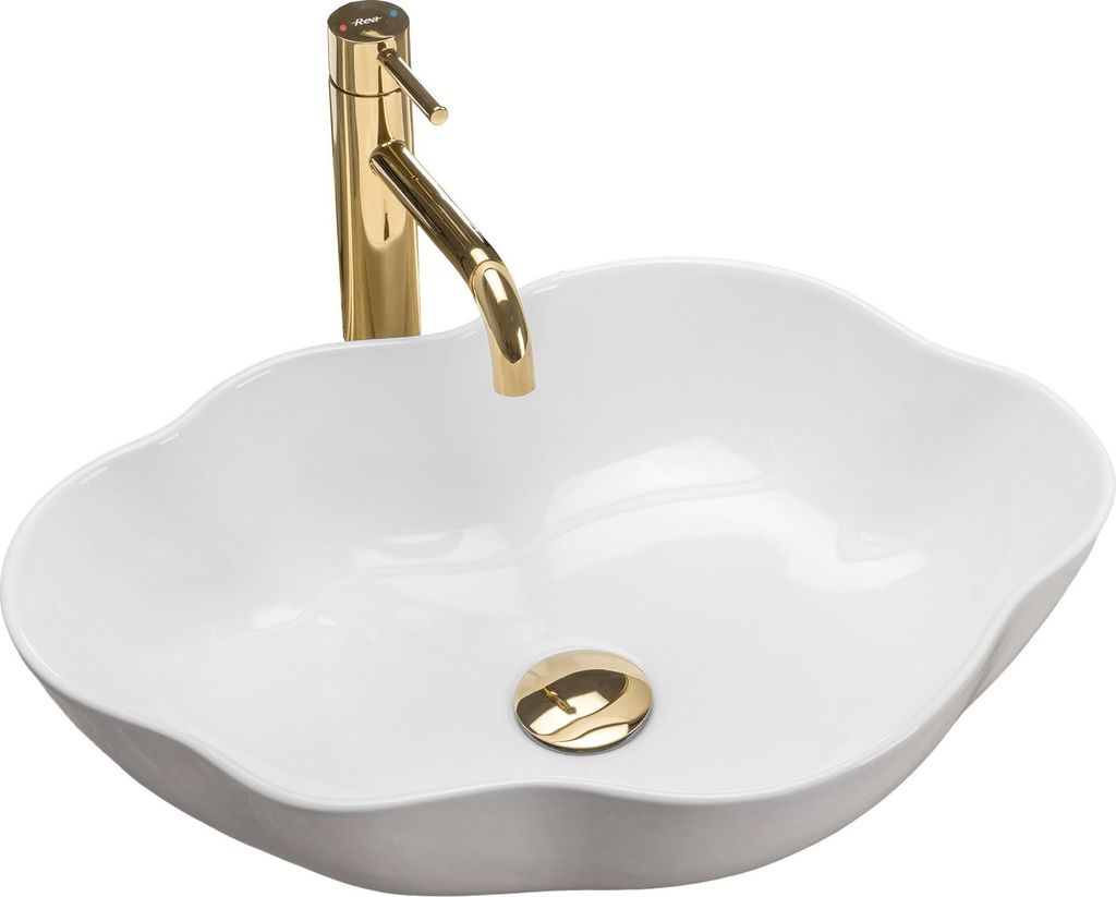 A white oval sink with a gold faucet and drain.