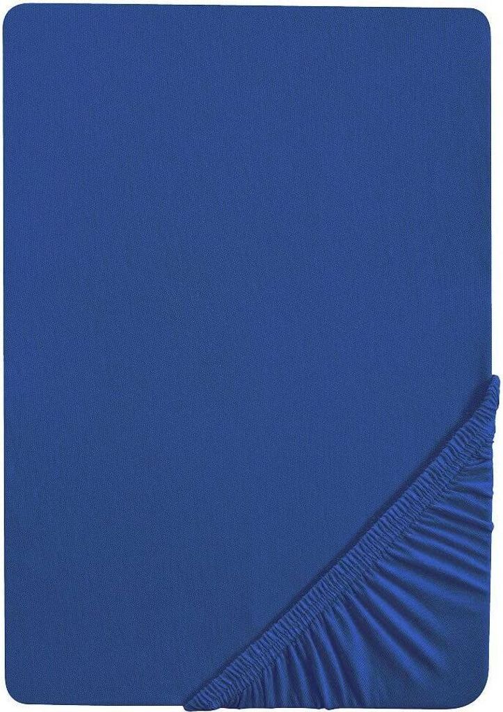 A blue fitted sheet is shown from a top-down perspective, with the elasticized corner visible in the bottom right.