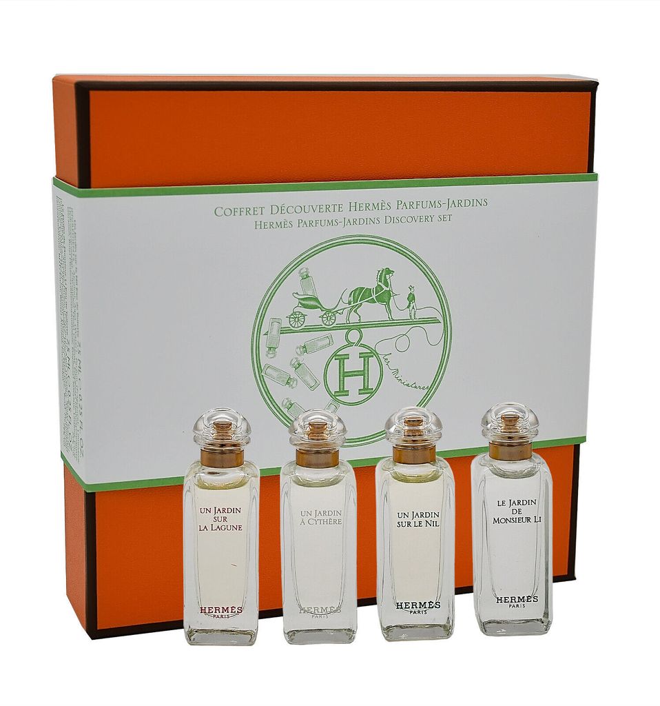 A set of four small perfume bottles in a gift box.