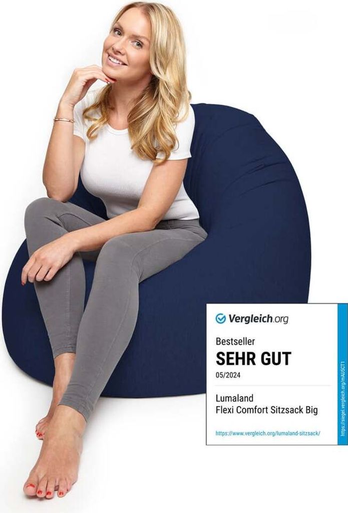A woman is sitting on a navy blue beanbag chair.