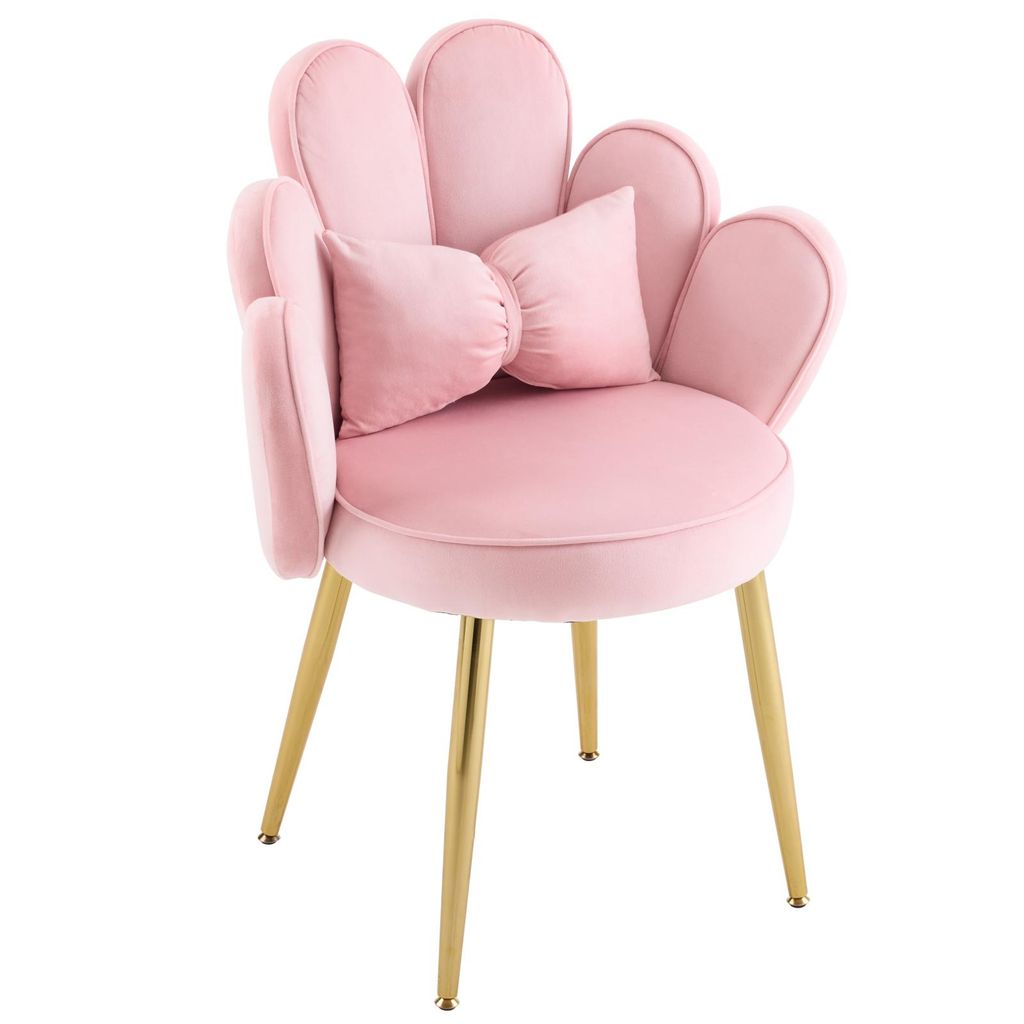 A pink velvet chair with gold legs and a bow-shaped pillow.
