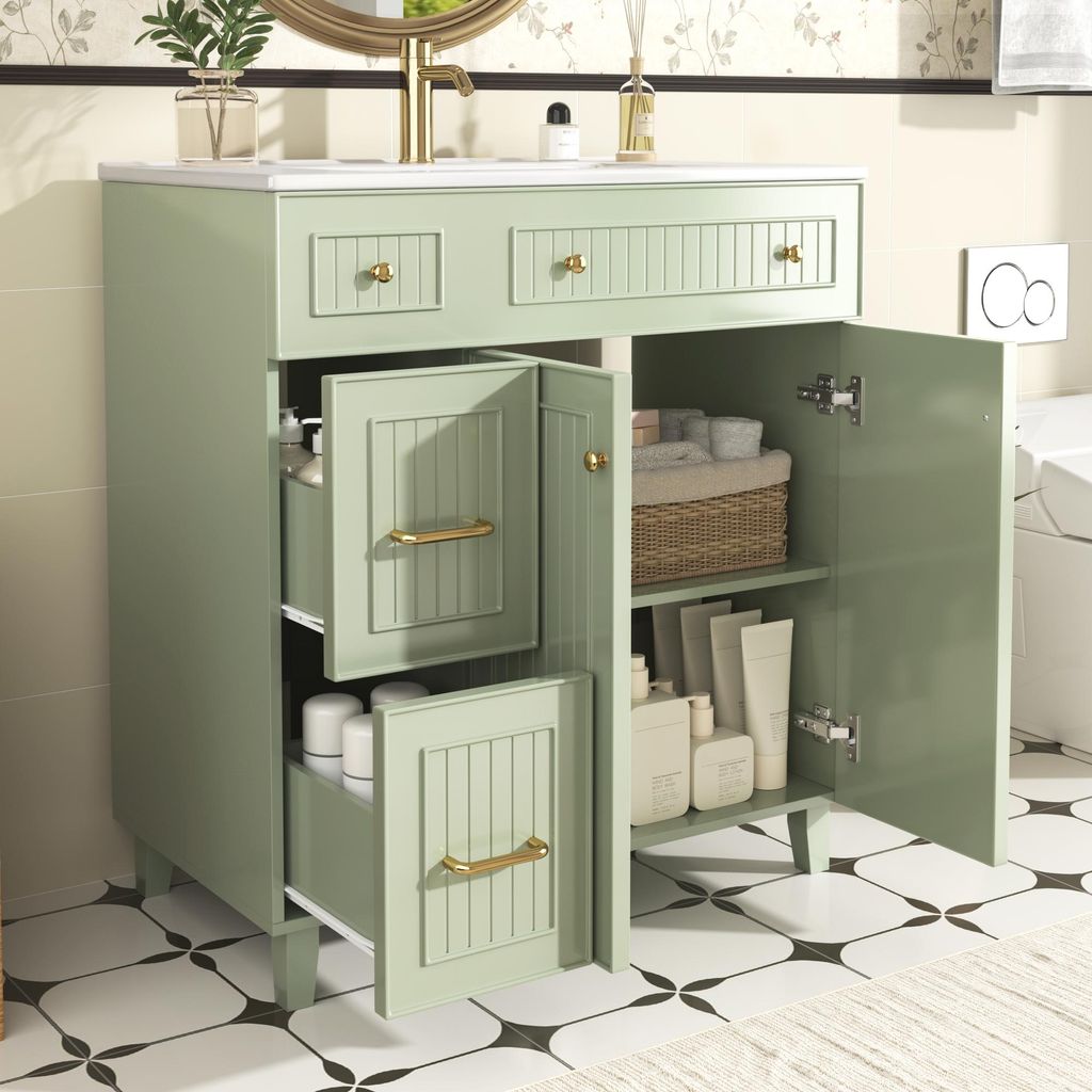 A green bathroom vanity with its doors and drawers open, showcasing storage space and toiletries.