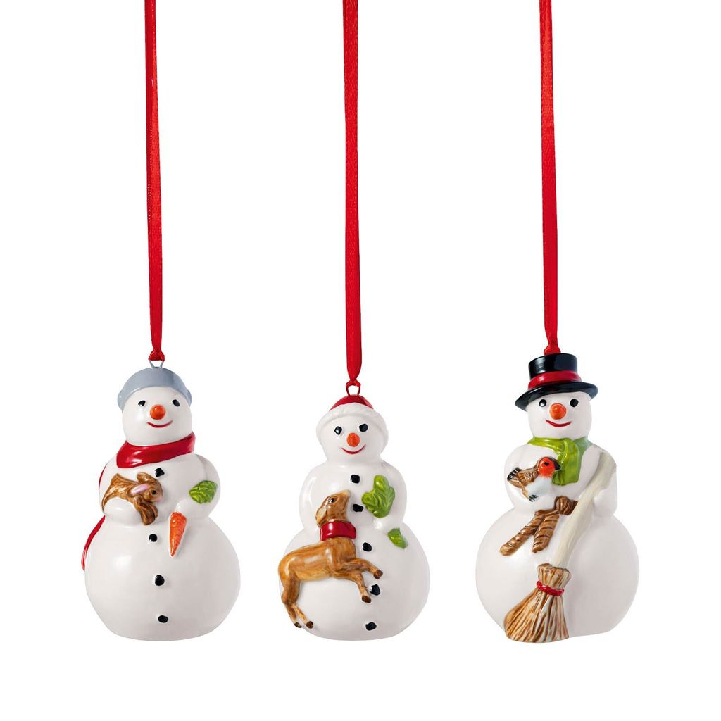Three ceramic snowman ornaments hanging from red ribbons against a white background.