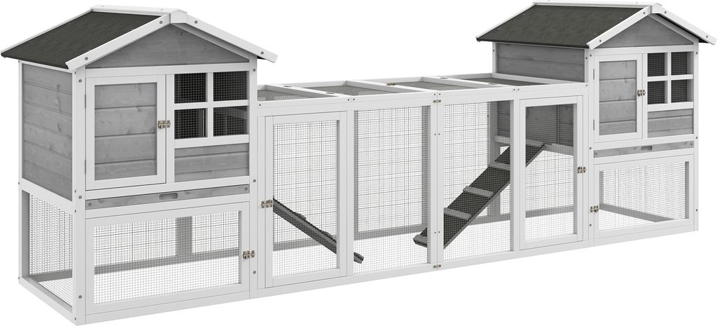 A long, multi-compartment wooden animal hutch with a ramp.