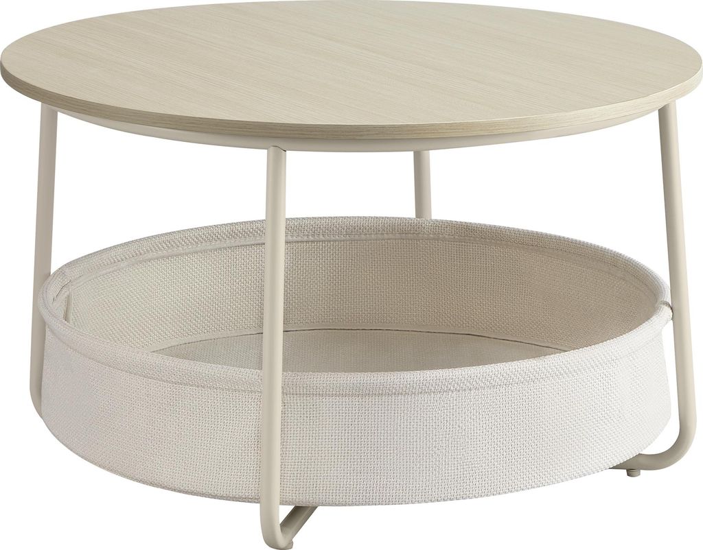 A round coffee table with a woven fabric basket underneath.