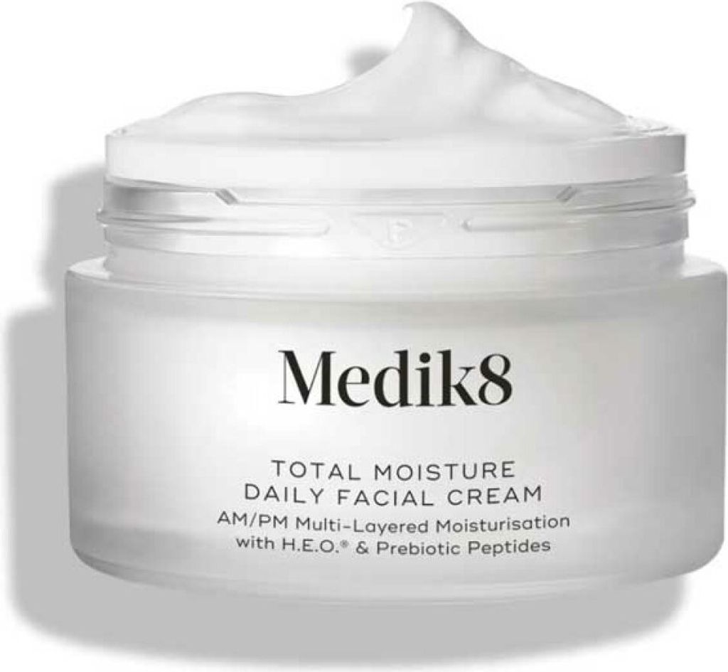 A white jar of Medik8 Total Moisture Daily Facial Cream with the lid slightly ajar and cream overflowing.