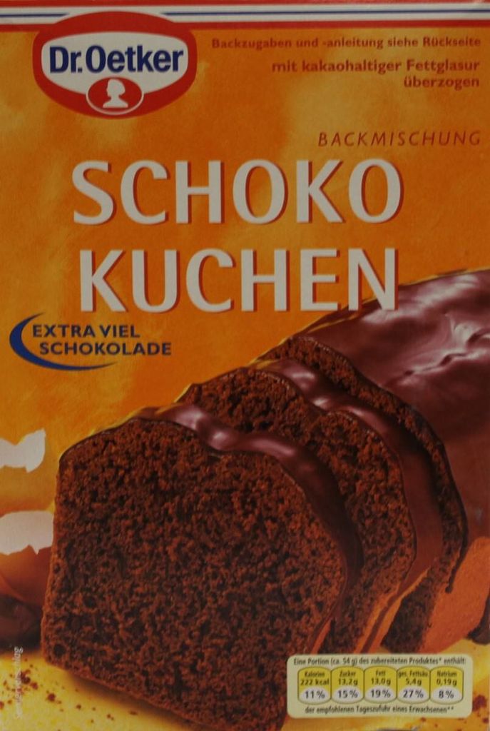 A close-up of a box of Dr. Oetker Schoko Kuchen (chocolate cake) baking mix, featuring an image of a sliced chocolate cake with chocolate glaze.