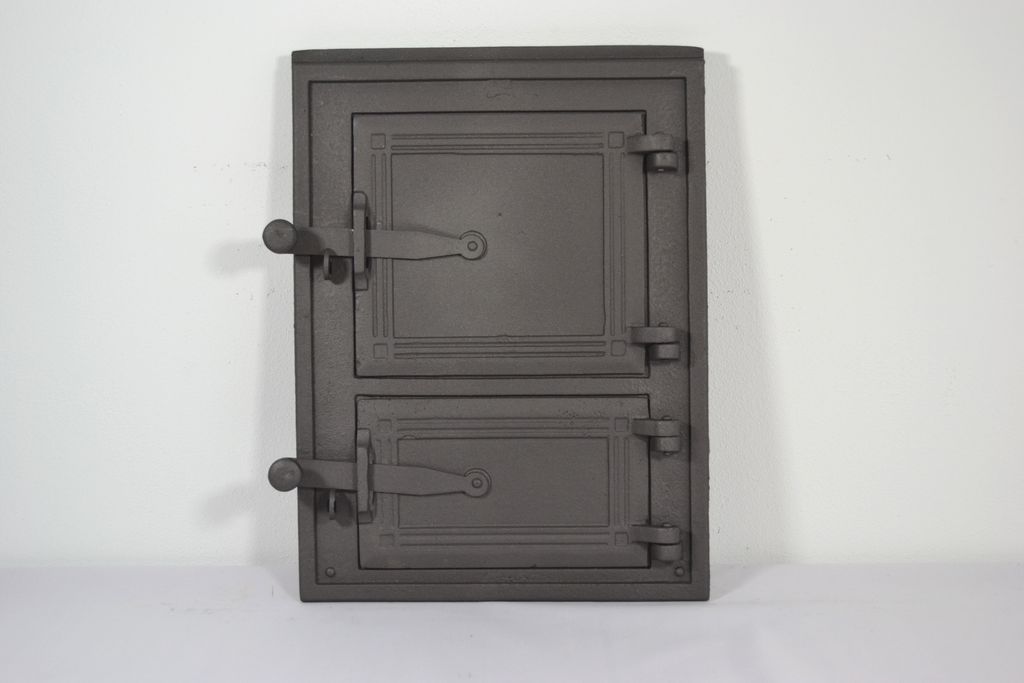 A dark gray cast iron door with two panels and two handles, set against a white background.