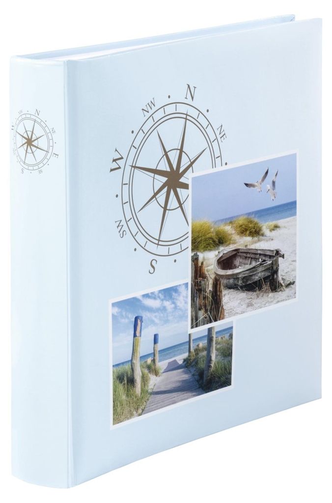 A light blue photo album with a compass design and two small beach-themed photos on the cover.