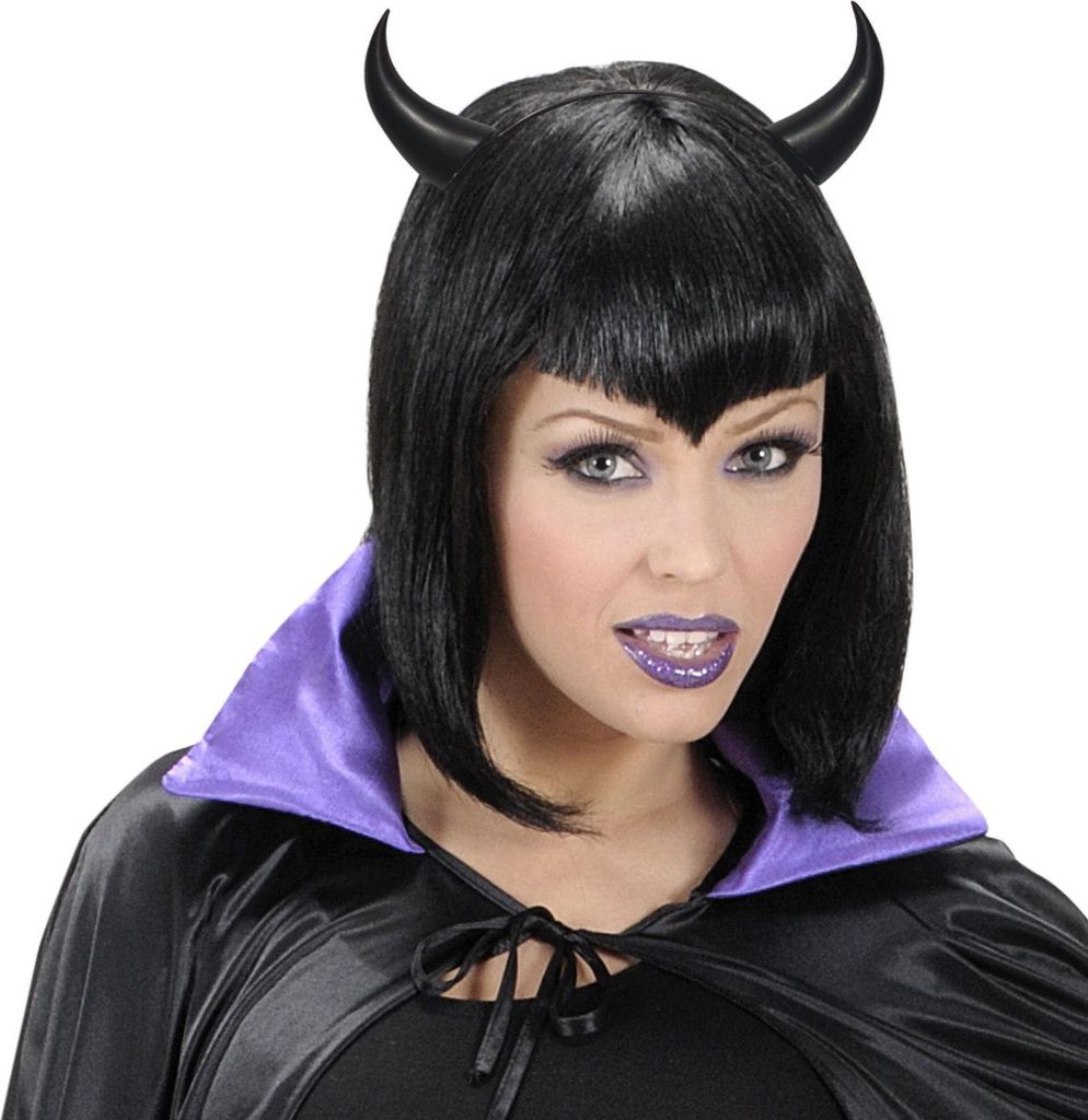 A woman wearing a black wig with devil horns and a black cape with a purple collar.
