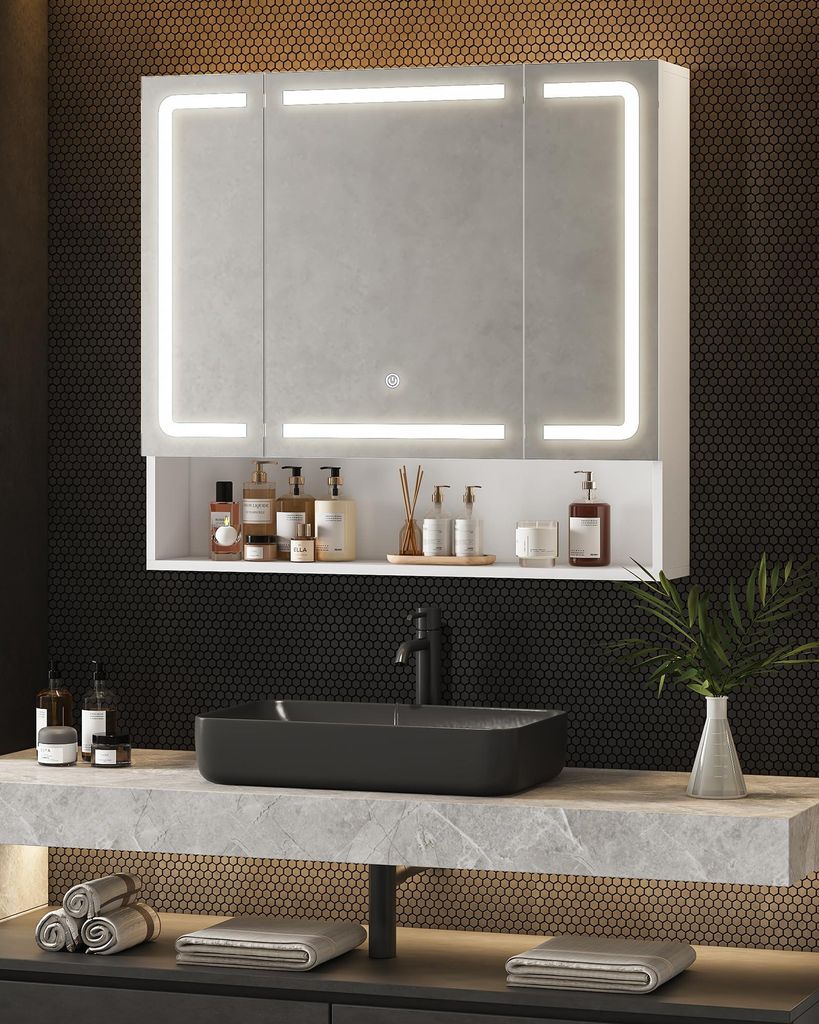 A modern bathroom vanity with a lighted mirror, sink, and accessories.