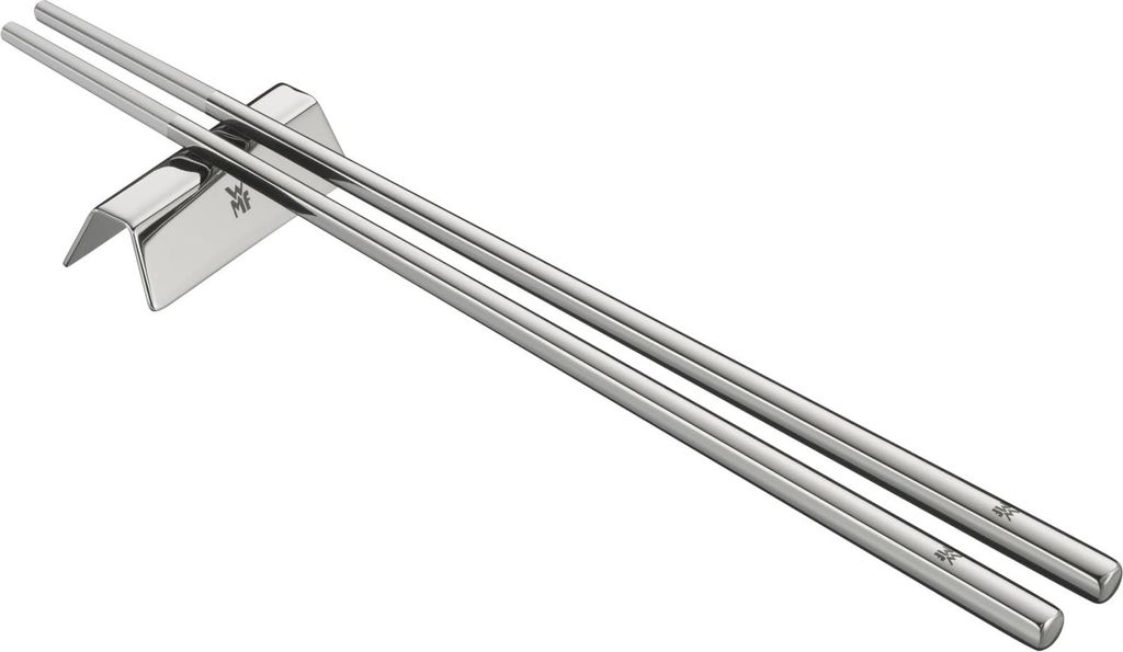 A pair of silver chopsticks resting on a silver chopstick rest.