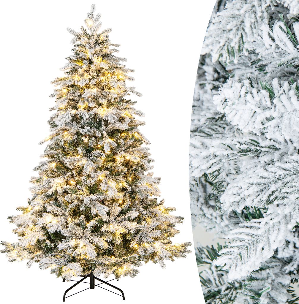 A flocked artificial Christmas tree with warm white lights.