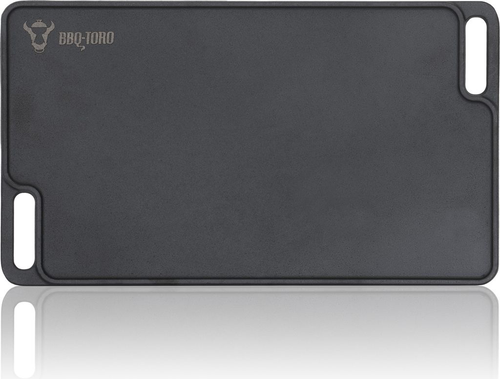 A black cast iron grill plate with handles, shown from a top-down perspective with a reflection below.