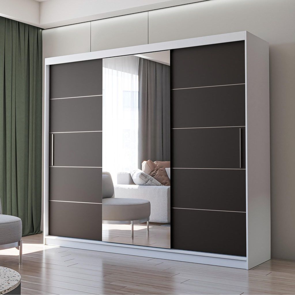 A modern sliding door wardrobe with a mirrored section, set in a well-lit room with curtains and a sofa visible in the reflection.