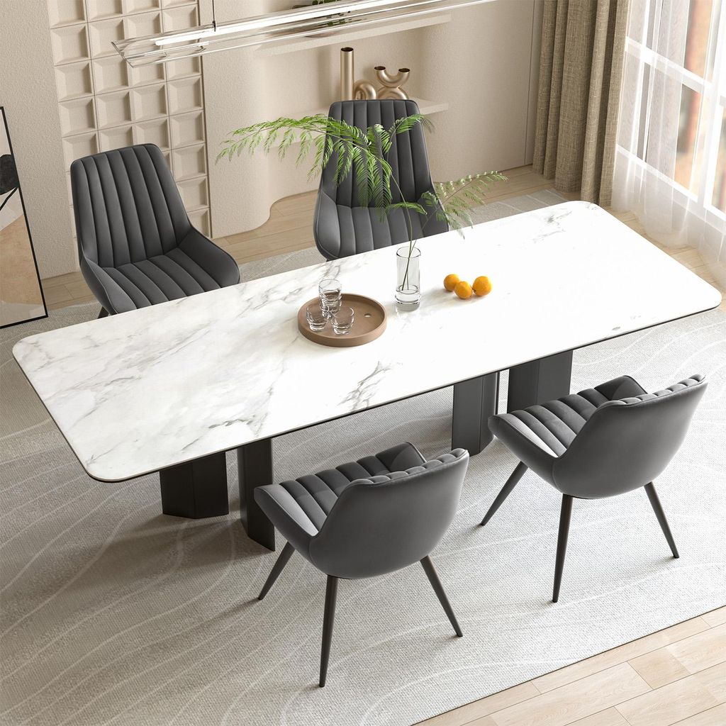 A dining room scene with a marble-top table and four chairs.
