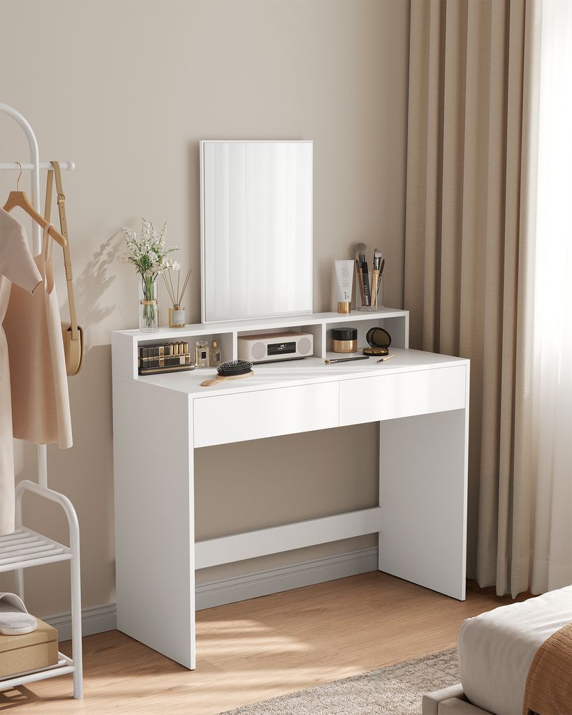 A white dressing table with a mirror and various cosmetics is shown.