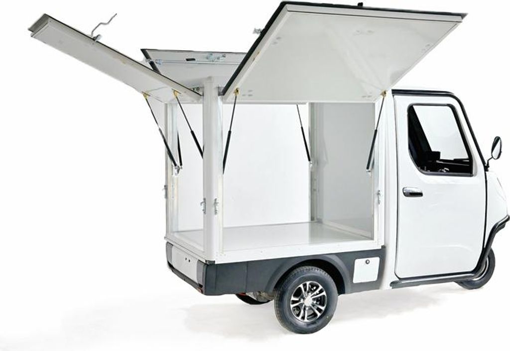A white three-wheeled cargo vehicle with its cargo bay doors open, shown from a rear-quarter angle against a white background.