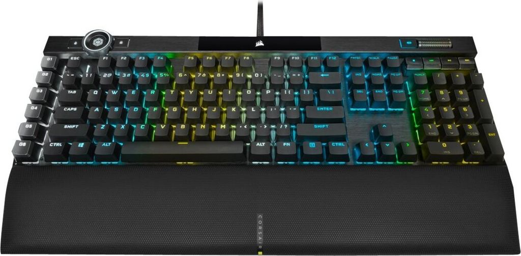 A Corsair K100 RGB Gaming Keyboard with RGB lighting is shown from a front-facing, slightly elevated angle against a white background. The keyboard includes a wrist rest.