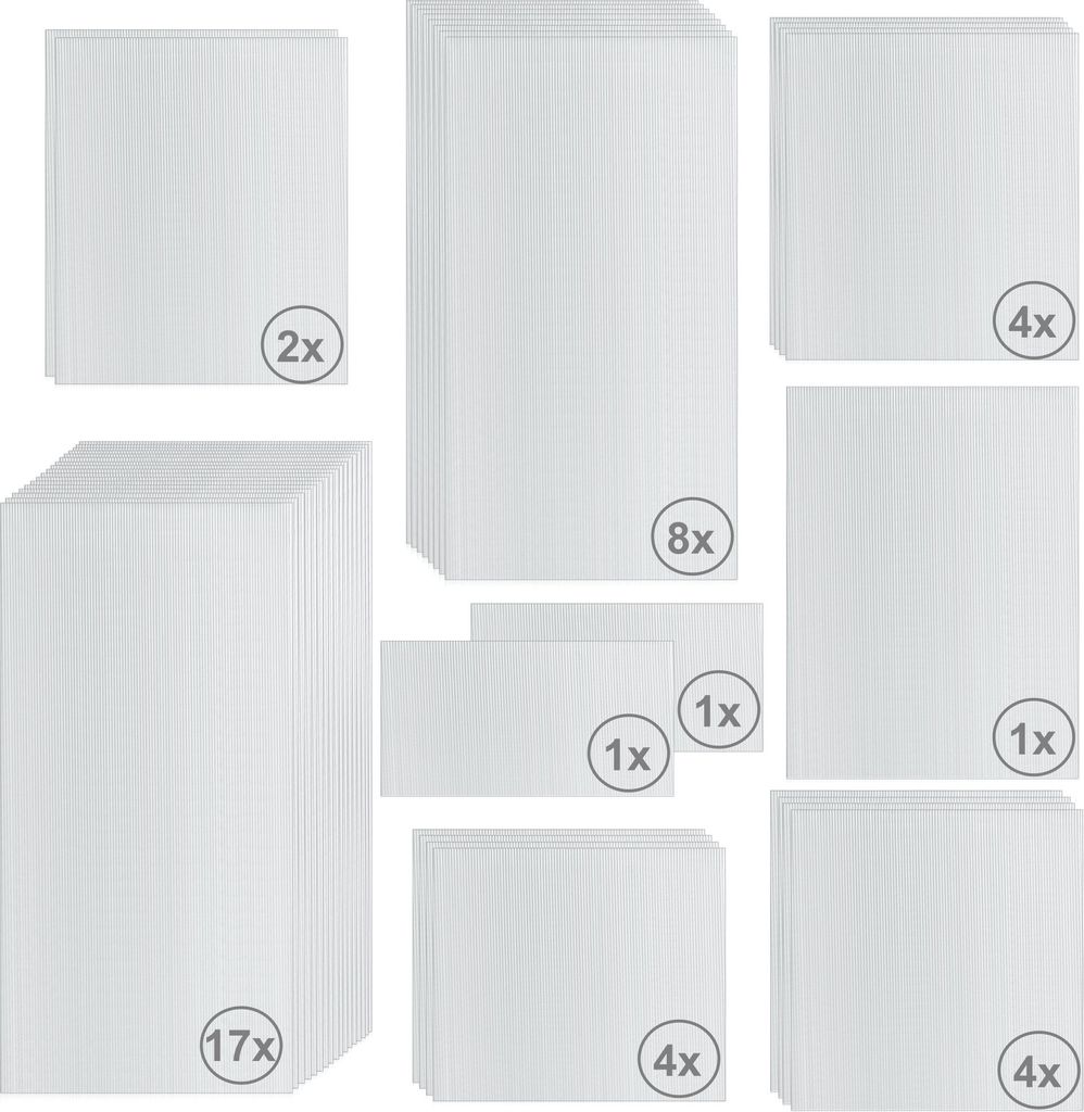 A collection of white corrugated plastic sheets, likely for a greenhouse, arranged in various stacks and sizes.