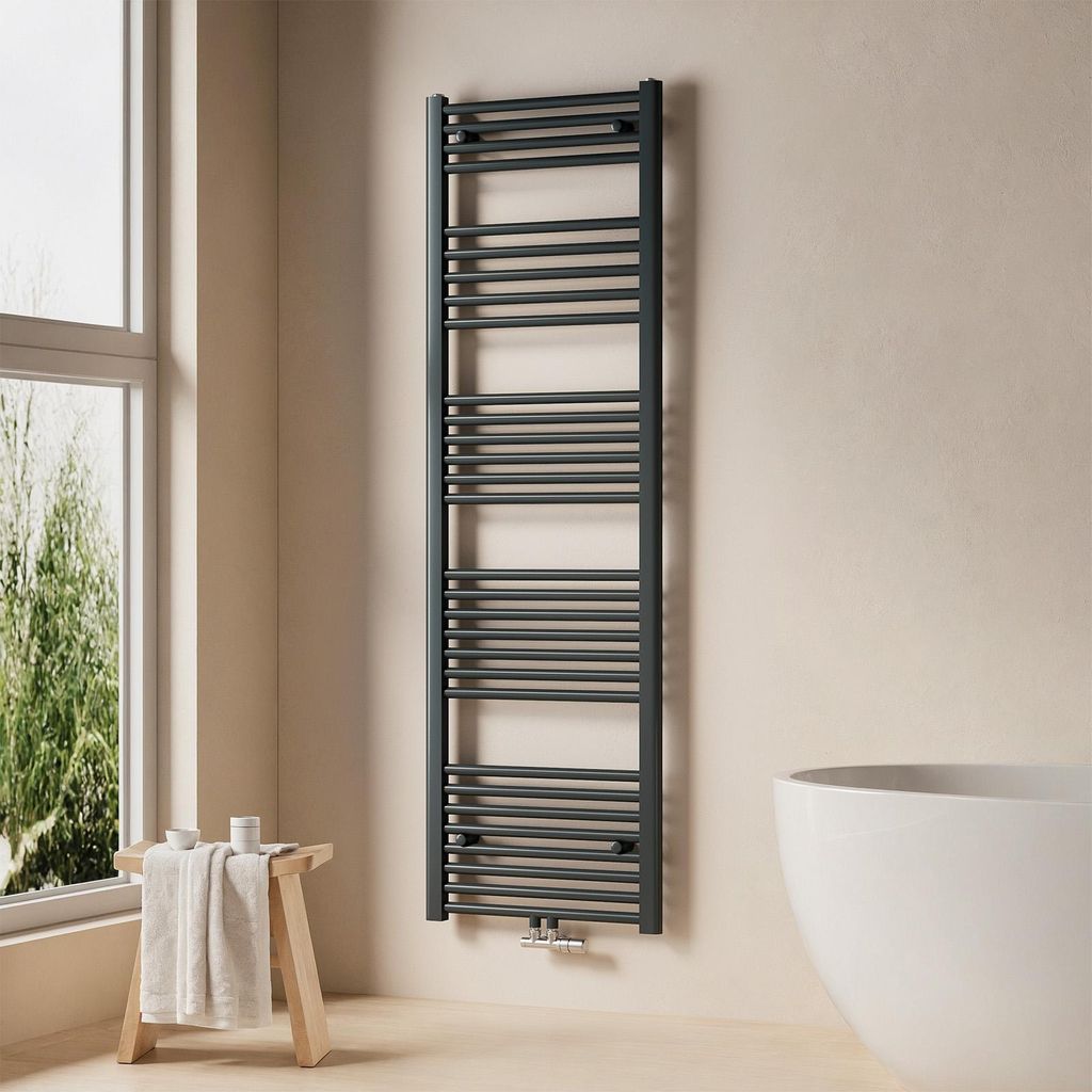 A modern bathroom with a dark grey towel radiator, a wooden stool with towels, and a white bathtub.