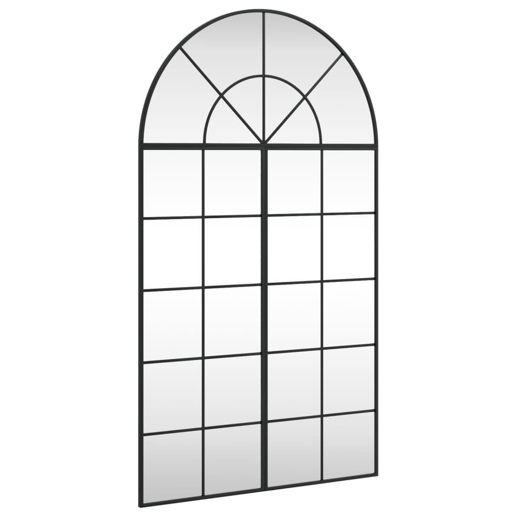 A full-shot of a black arched window mirror against a white background.