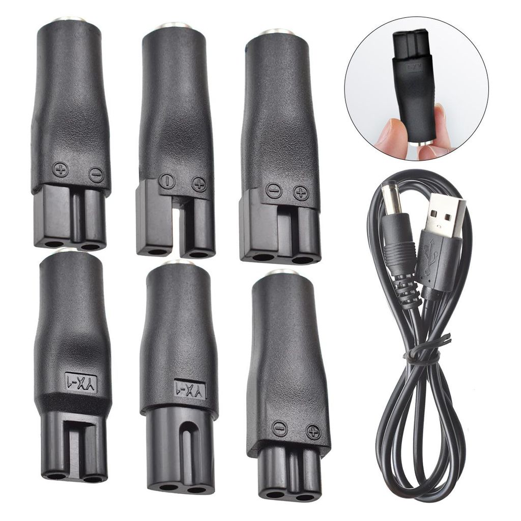 A collection of black electronic adapters and a USB charging cable are arranged on a white background.