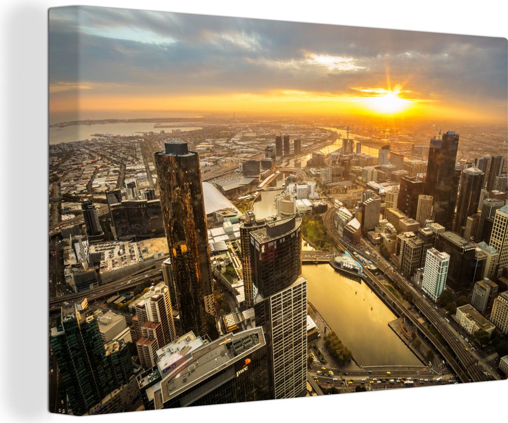 OneMillionCanvasses - Leinwandbilder - 140x90 cm, Die untergehende Sonne wirft goldene Strahlen über die Stadt Melbourne in Australien, Wandbild...