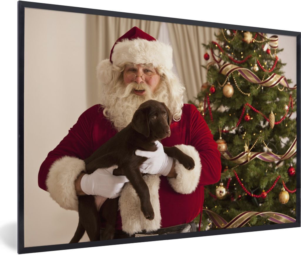 MuchoWow Gerahmtes Poster Der Weihnachtsmann mit einem braunen Hund in den Händen 60x40 cm - Poster mit Schwarzem Bilderrahmen Wandposter Rahmen...