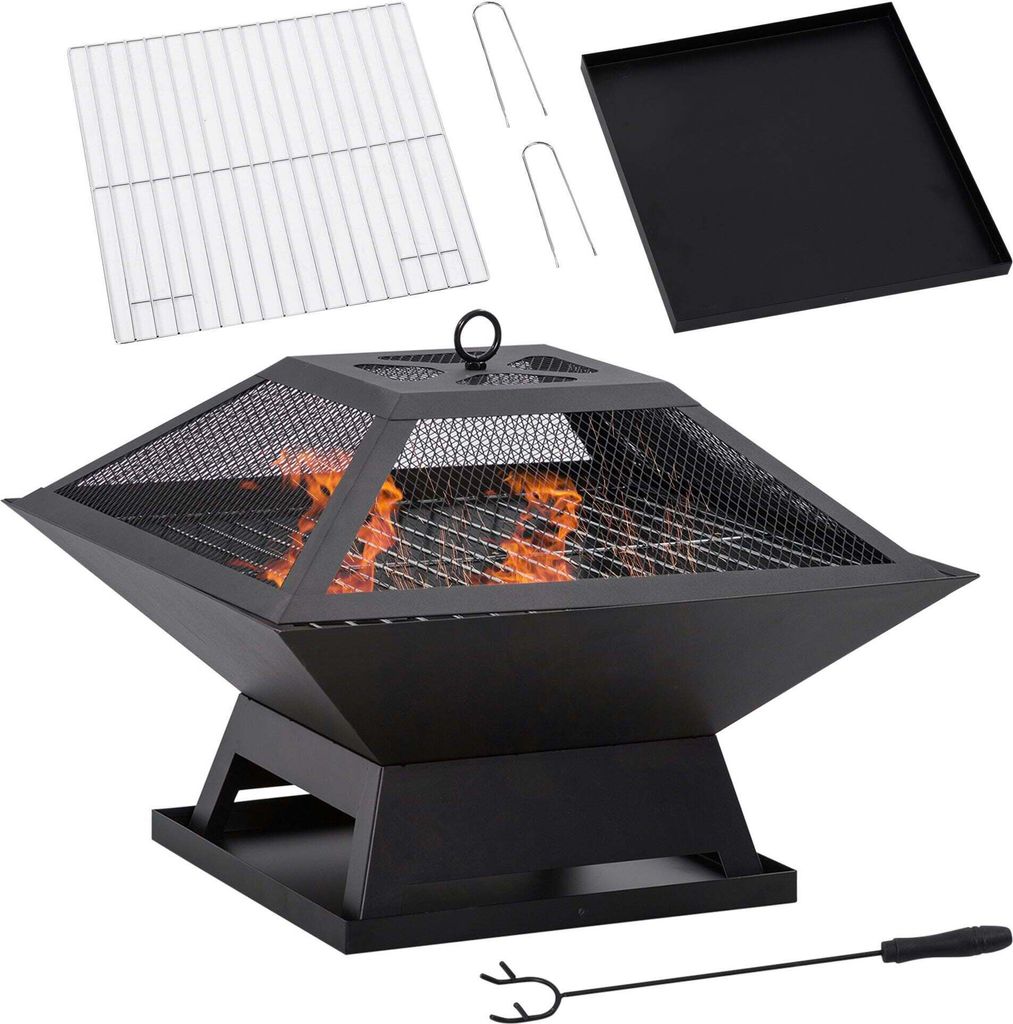 A fire pit with accessories laid out around it.