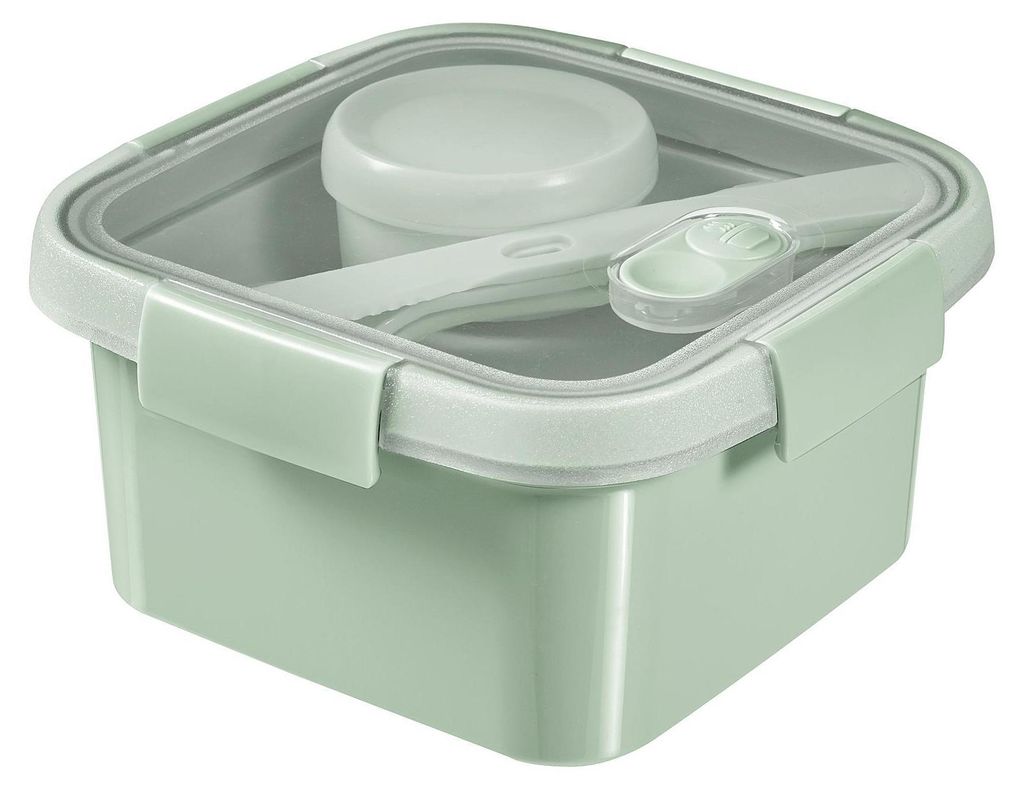 A square green lunchbox with a transparent lid and a small container inside, along with cutlery.