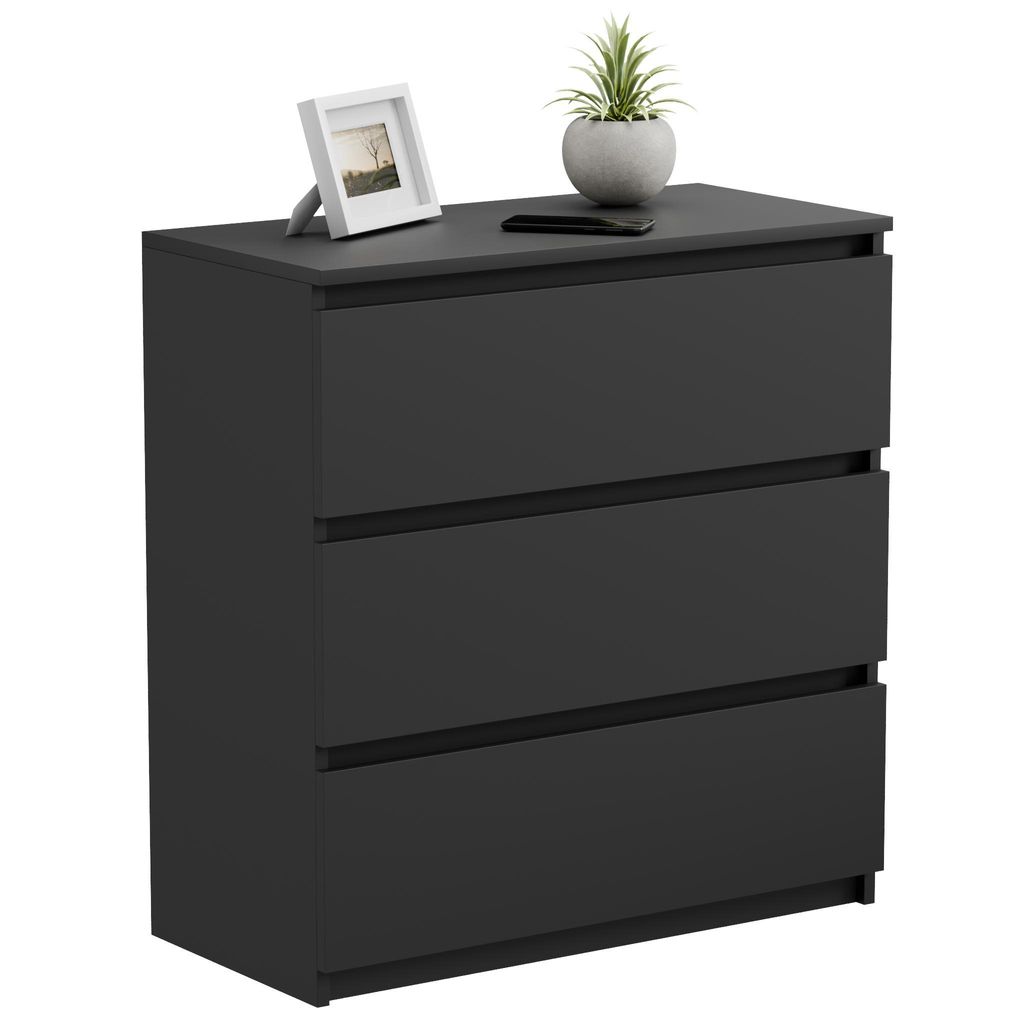 A black dresser with three drawers, a framed picture, and a potted plant on top, set against a white background.