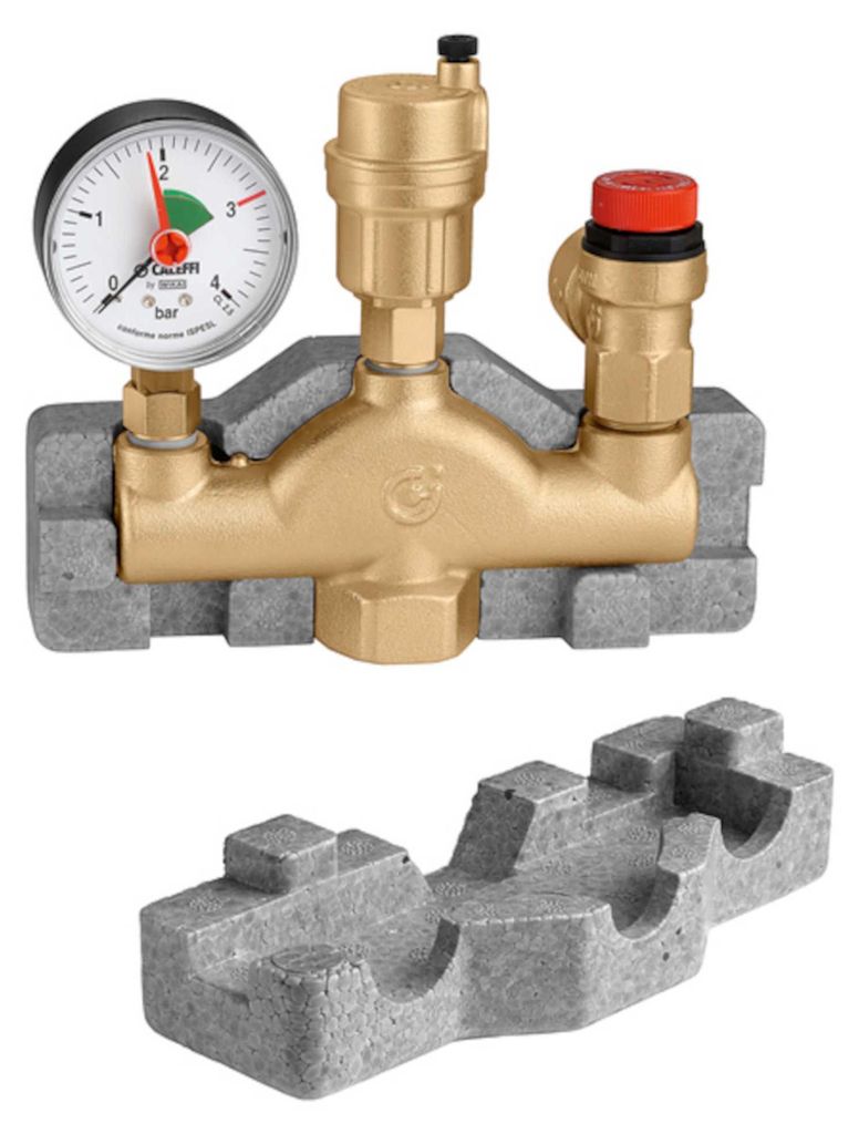 A close-up studio shot of a Caleffi Kesselsicherheitsgruppe (boiler safety group) with a pressure gauge and safety valve, resting on a grey insulating foam base. A separate piece of the insulating foam base is shown below.