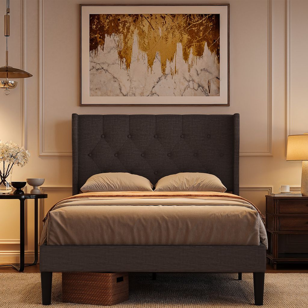 A bedroom scene featuring a bed, artwork, and a nightstand.