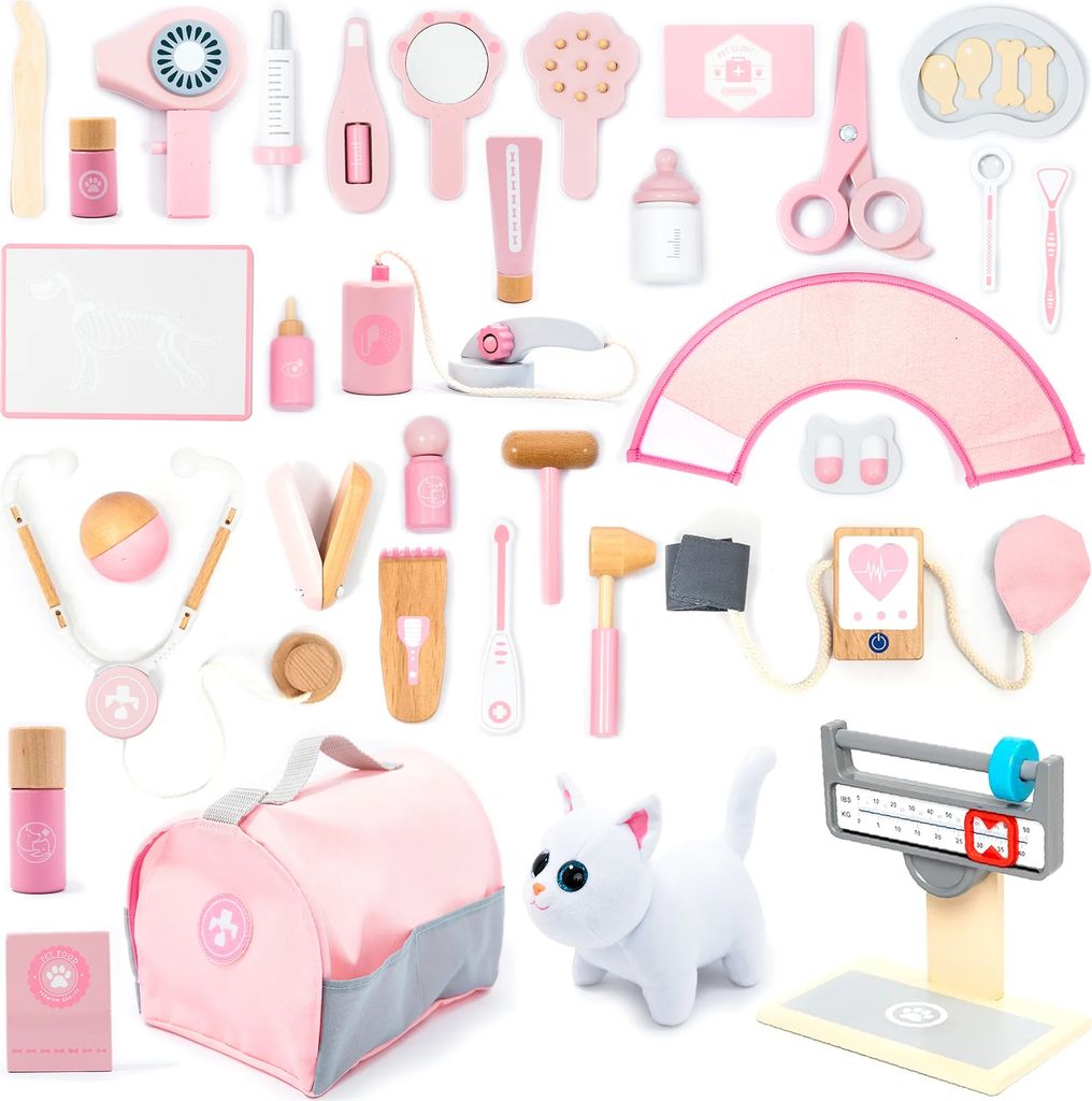 A collection of pink and wooden toy veterinary items arranged on a white background.