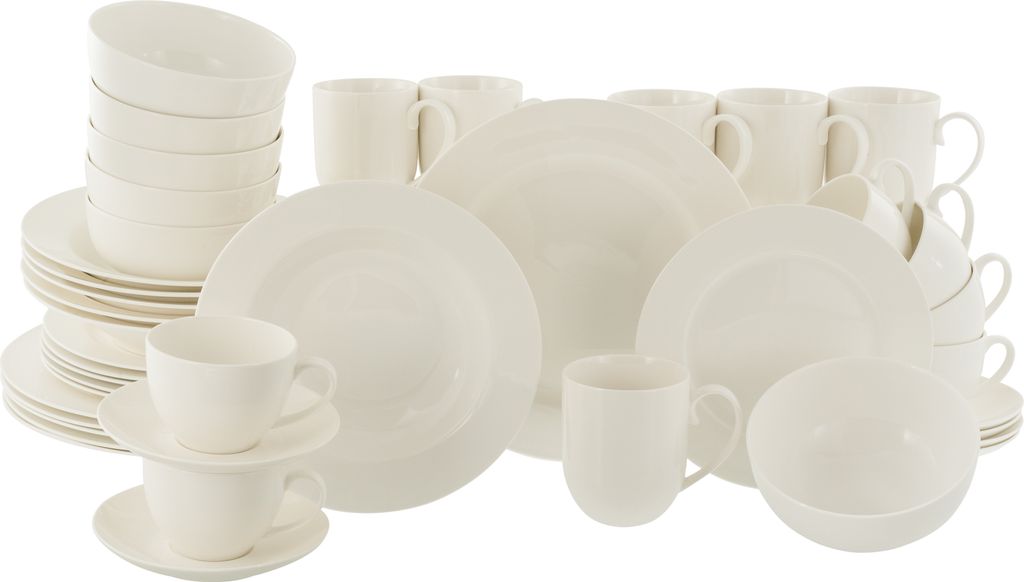 A collection of white ceramic dinnerware, including plates, bowls, and mugs, arranged on a white background.