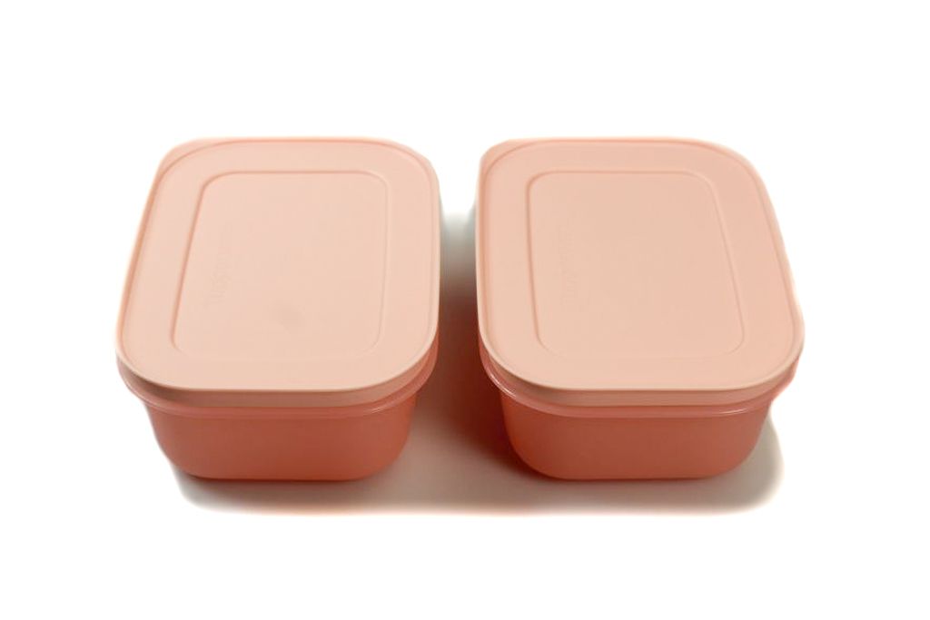 Two pink food storage containers with lids are shown side-by-side on a white background.