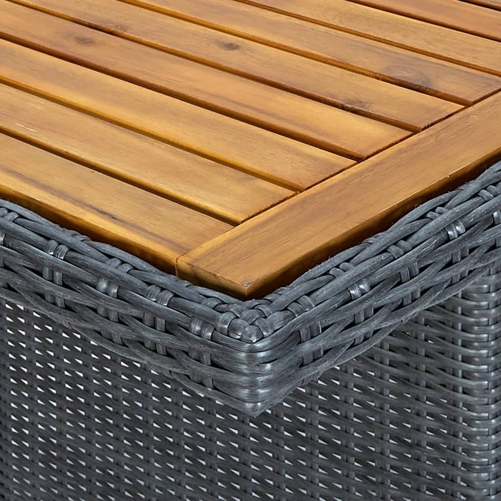 Close-up of the corner of a table, showing the wooden top and the woven rattan base.