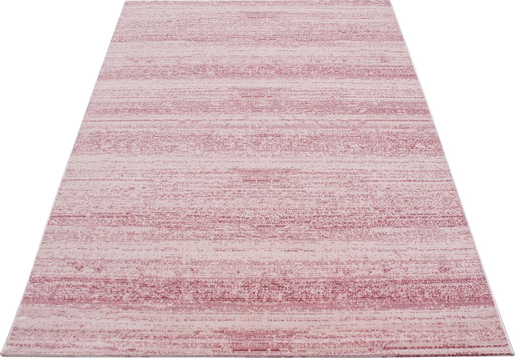 A close-up, angled view of a pink and white striped rug.