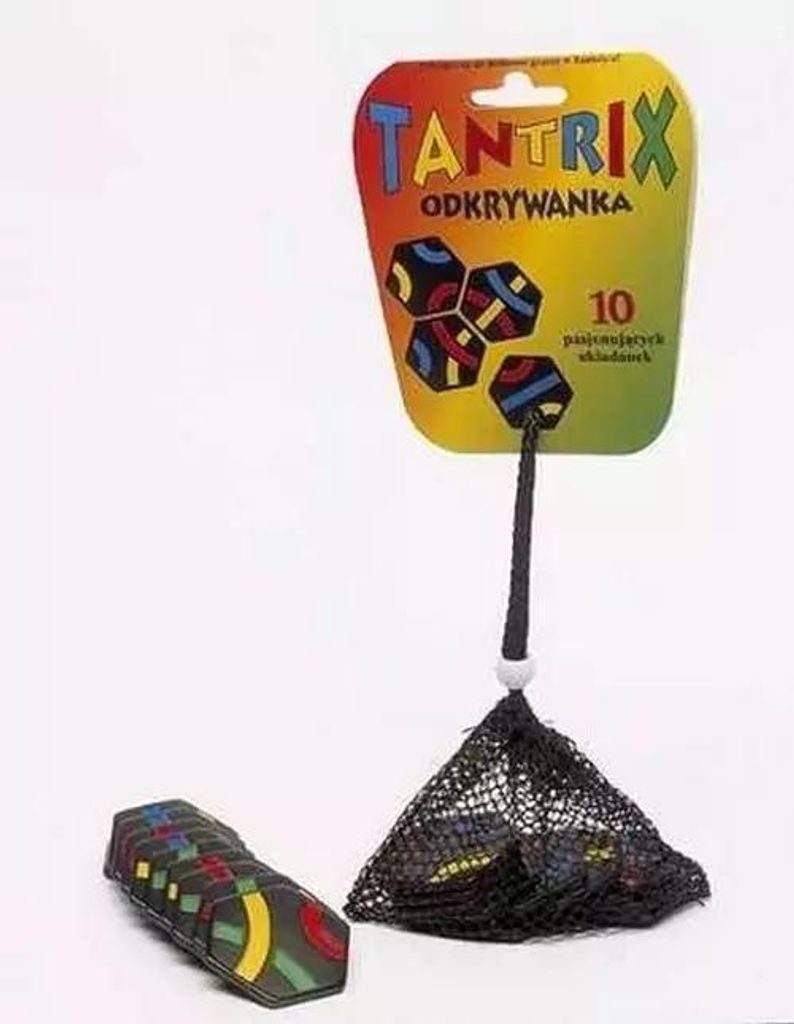 A Tantrix Discovery puzzle game packaging with a net bag of puzzle pieces hanging from it.