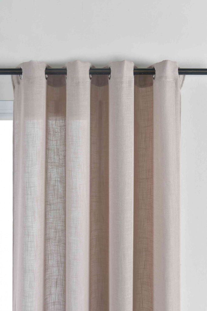 A close-up view of a curtain hanging from a curtain rod.