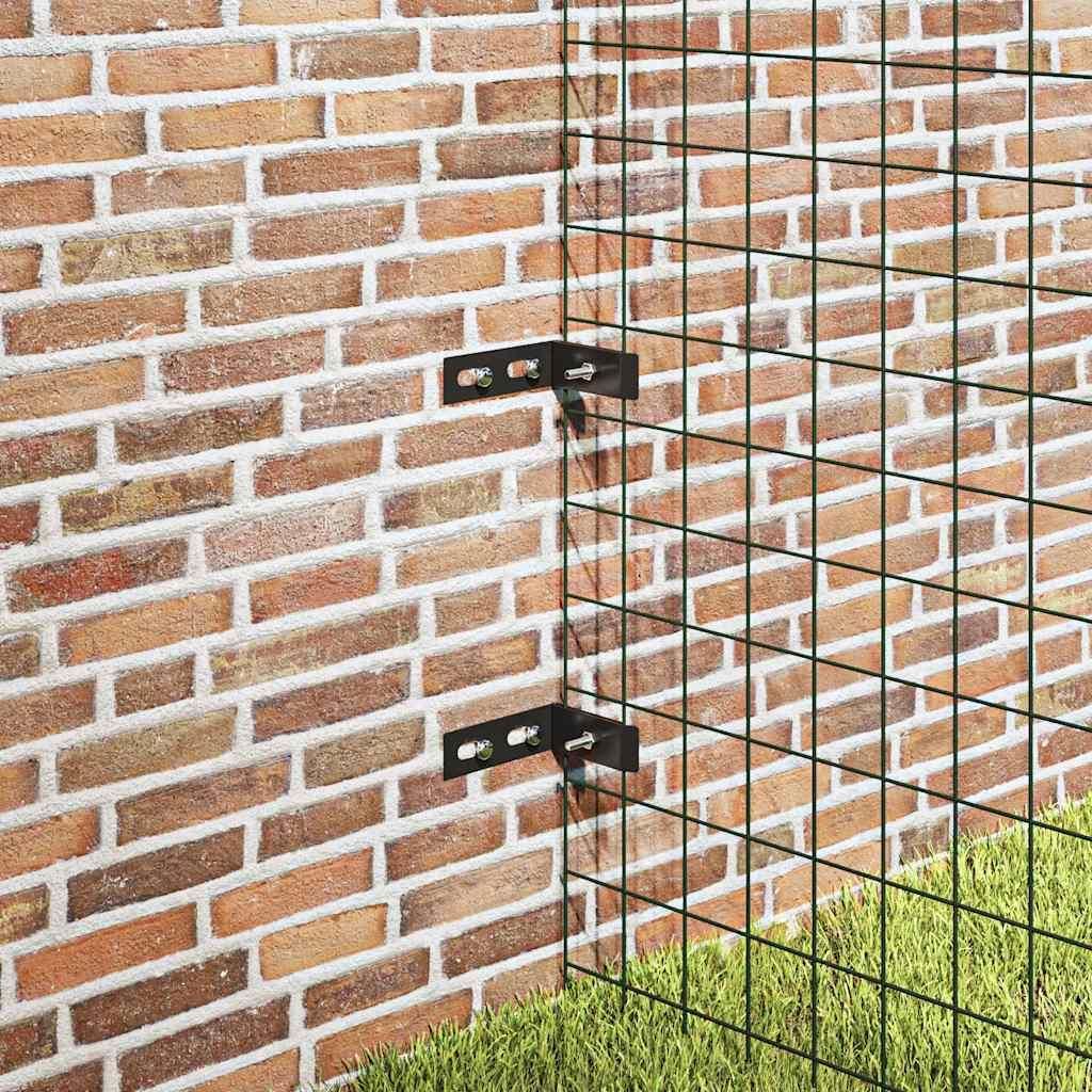 Corner brackets attaching a green wire mesh fence to a brick wall, with grass in the foreground.