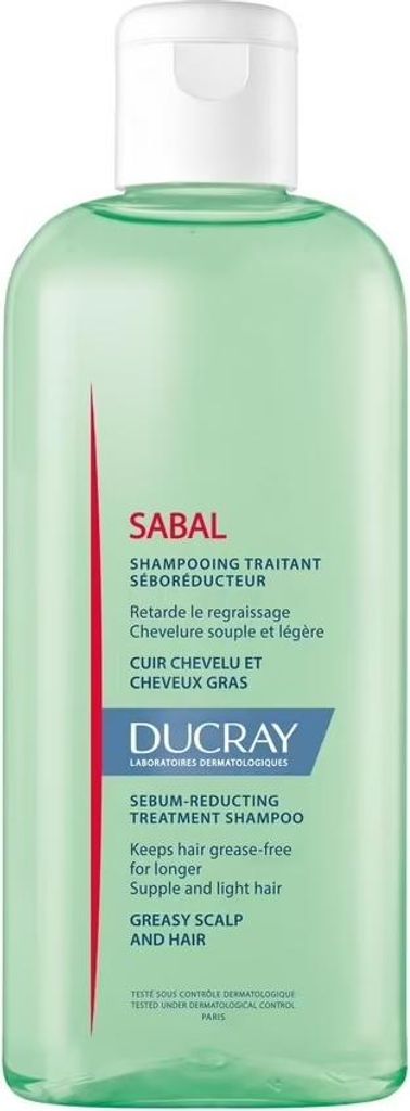 A product shot of a green shampoo bottle with a white cap and a label with text and a red stripe.