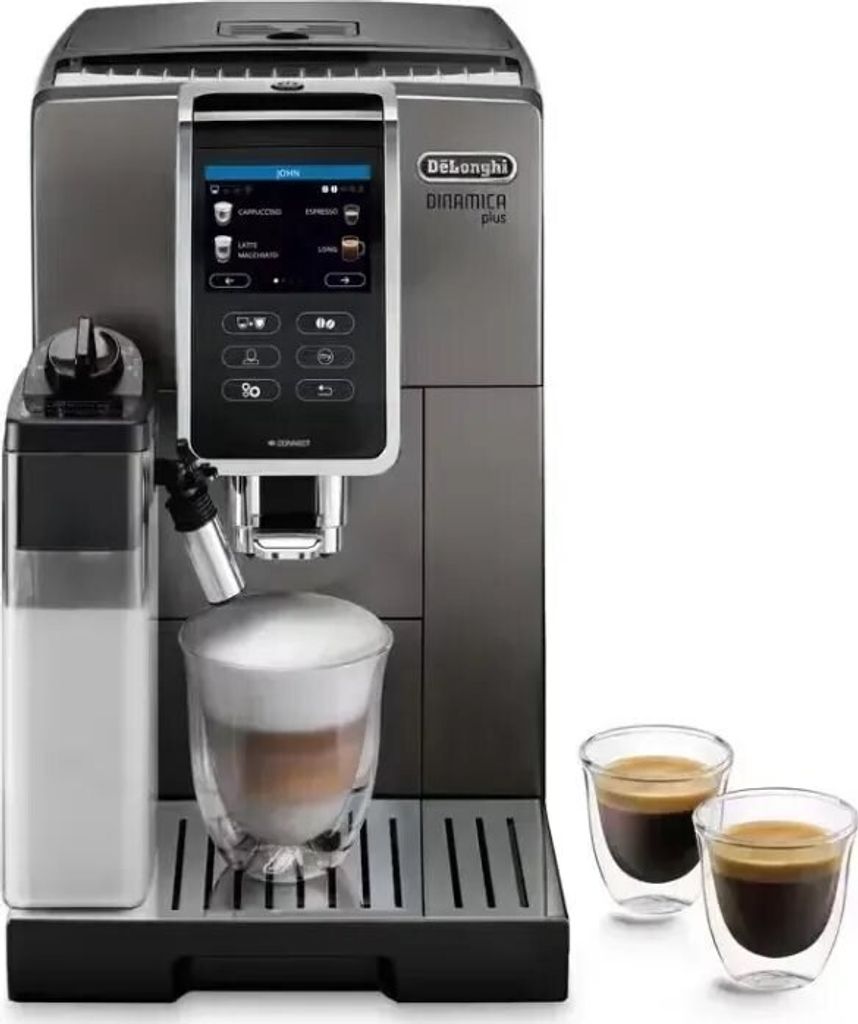 A De Longhi Dinamica Plus automatic coffee machine is shown with a glass of coffee with foam, a milk container, and two small espresso cups.