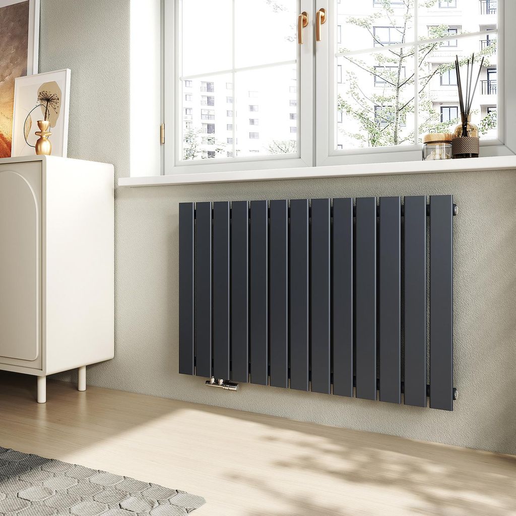 A modern living room with a radiator under a window.